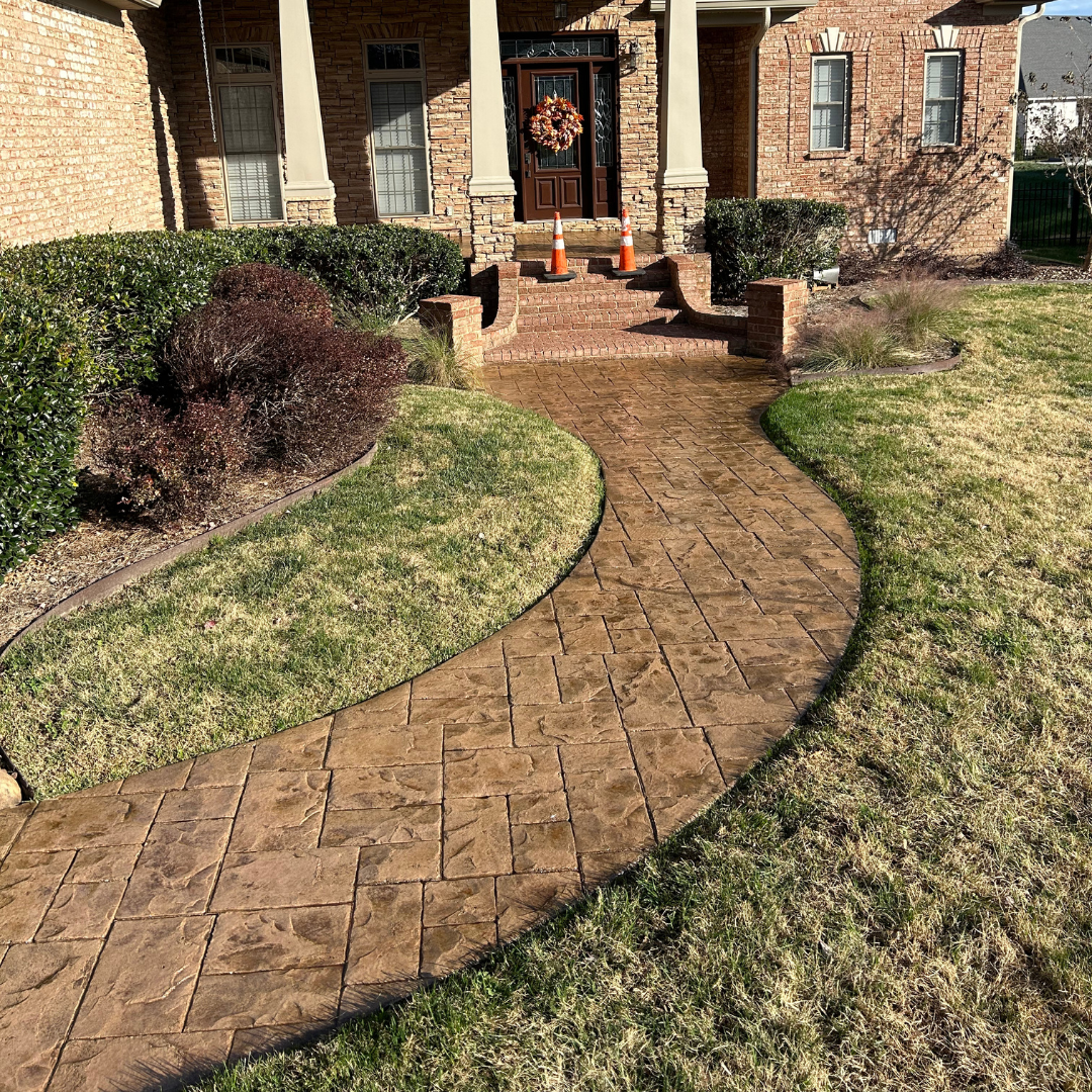 A brick walkway leading to the front door of a house.