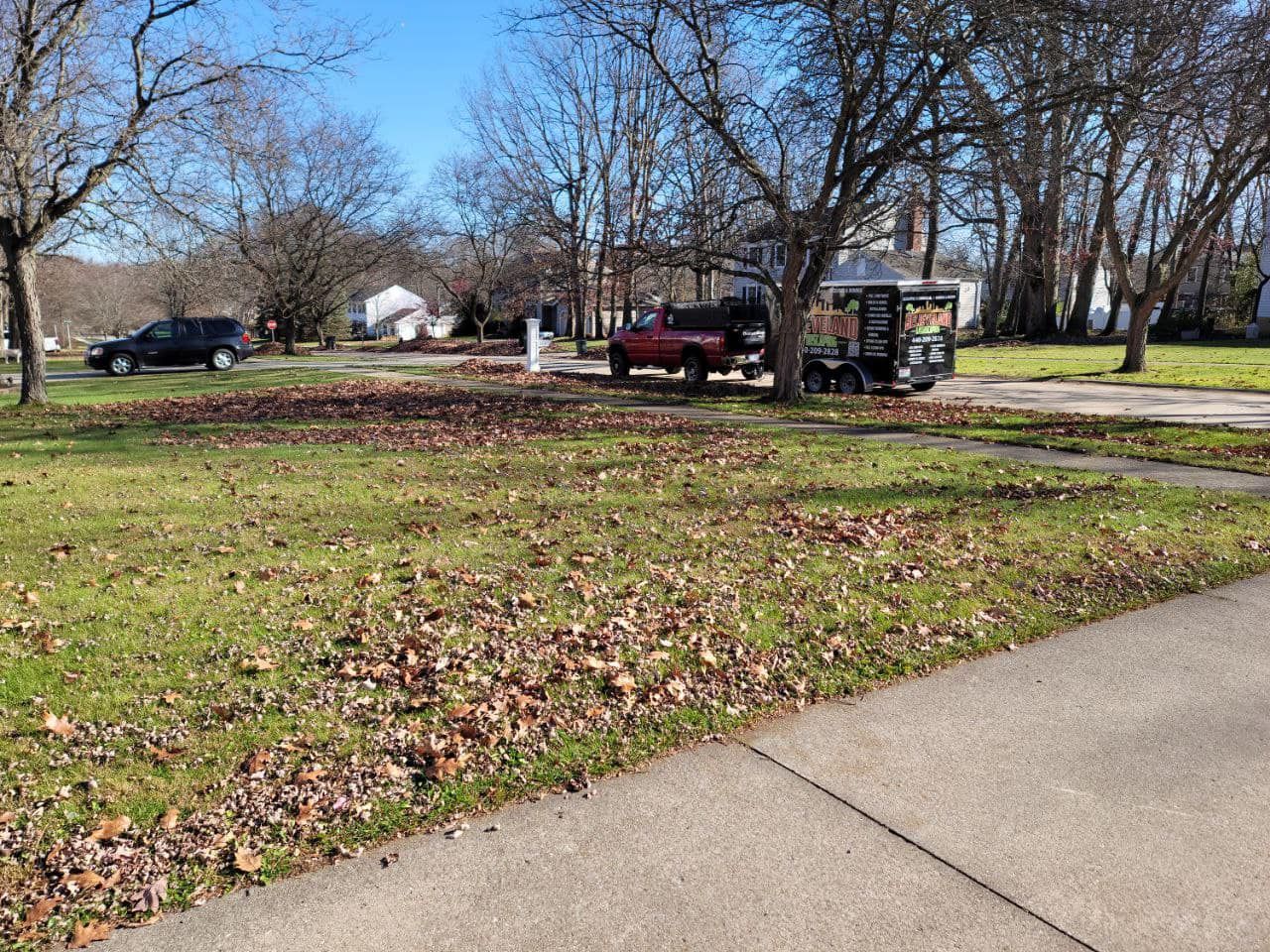 Red Truck is Parked in a Grassy Field — Northeast OH — Believeland Landscaping and Snow Removal