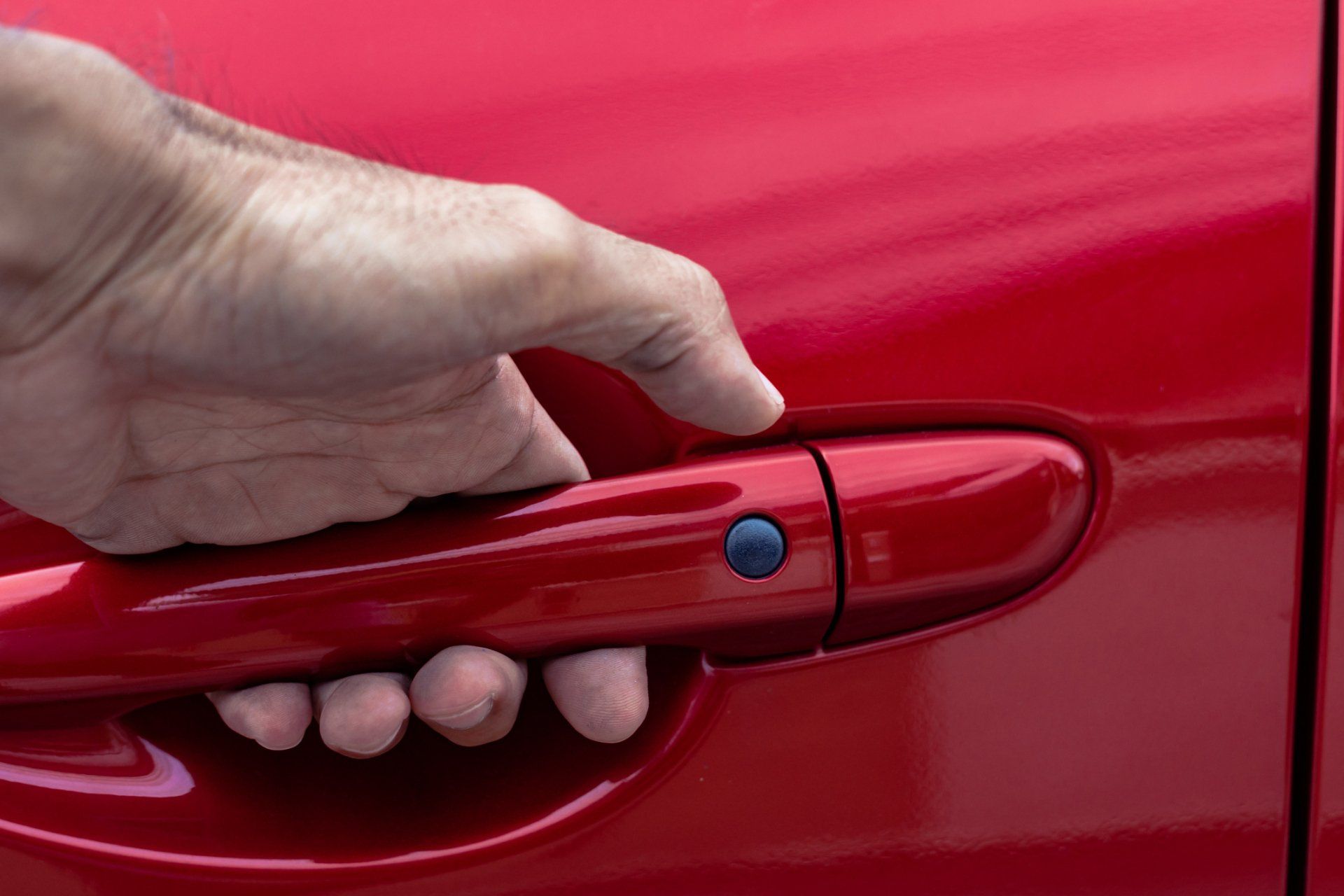 Man Opens Red Car Door — San Lorenzo, CA — PWT Professional Window Tinting & Car Audio