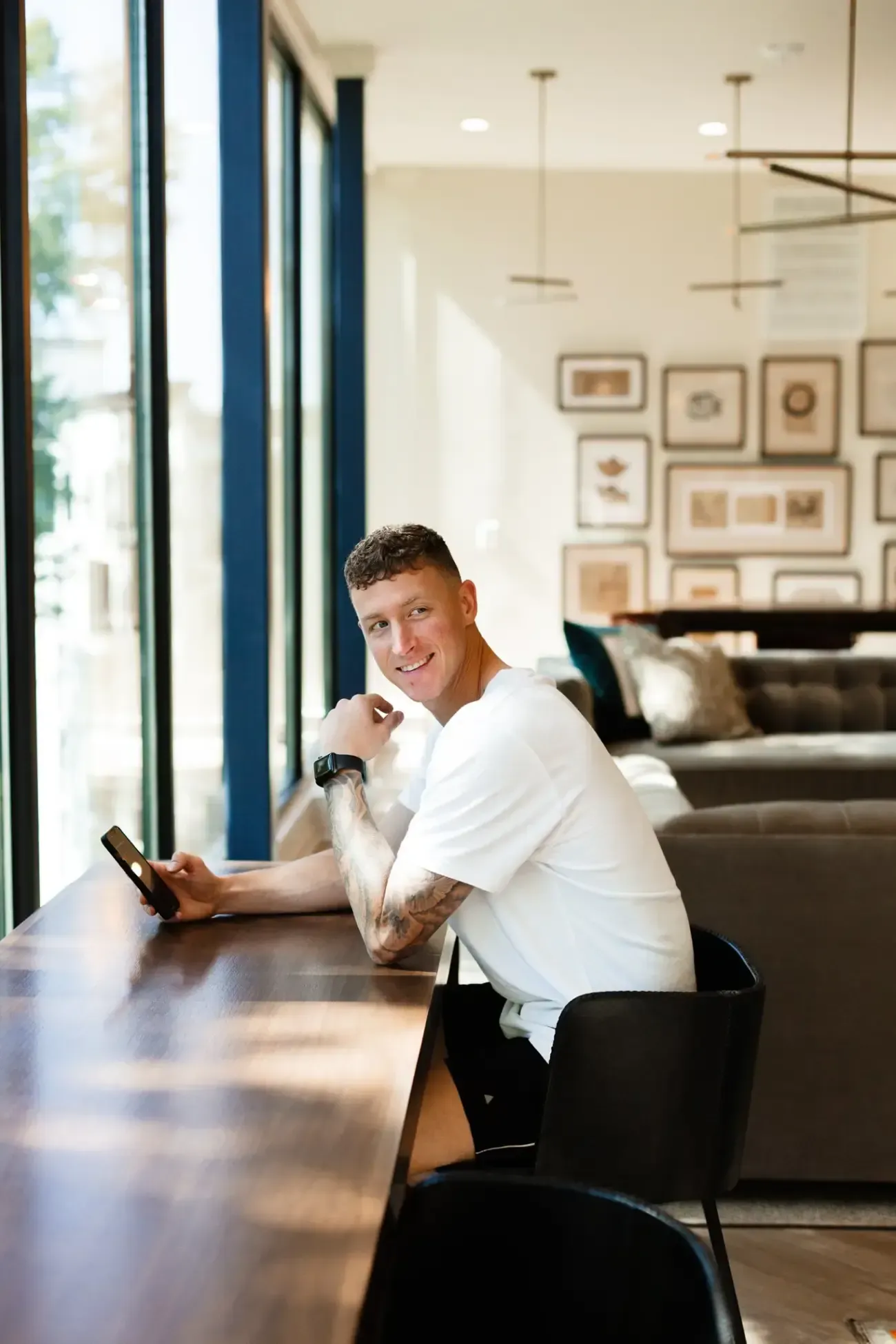 Resident Sitting at Bar at Ilion Apartments.