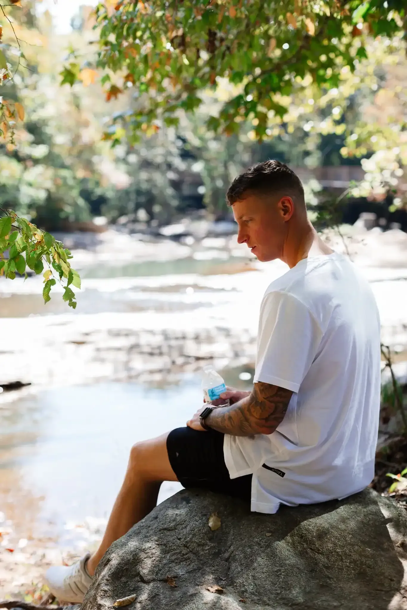 Resident Sitting by Water at Ilion Apartments.