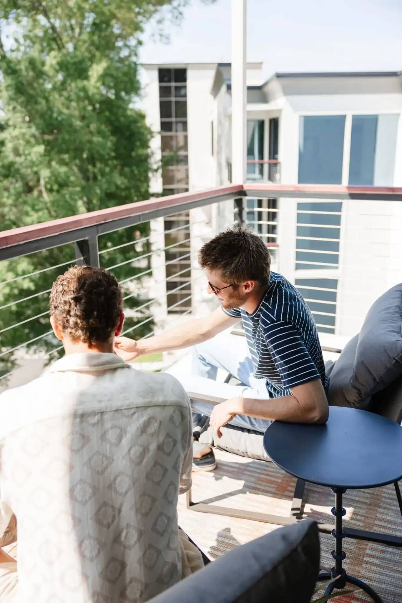 Residents on Balcony at Ilion Apartments.