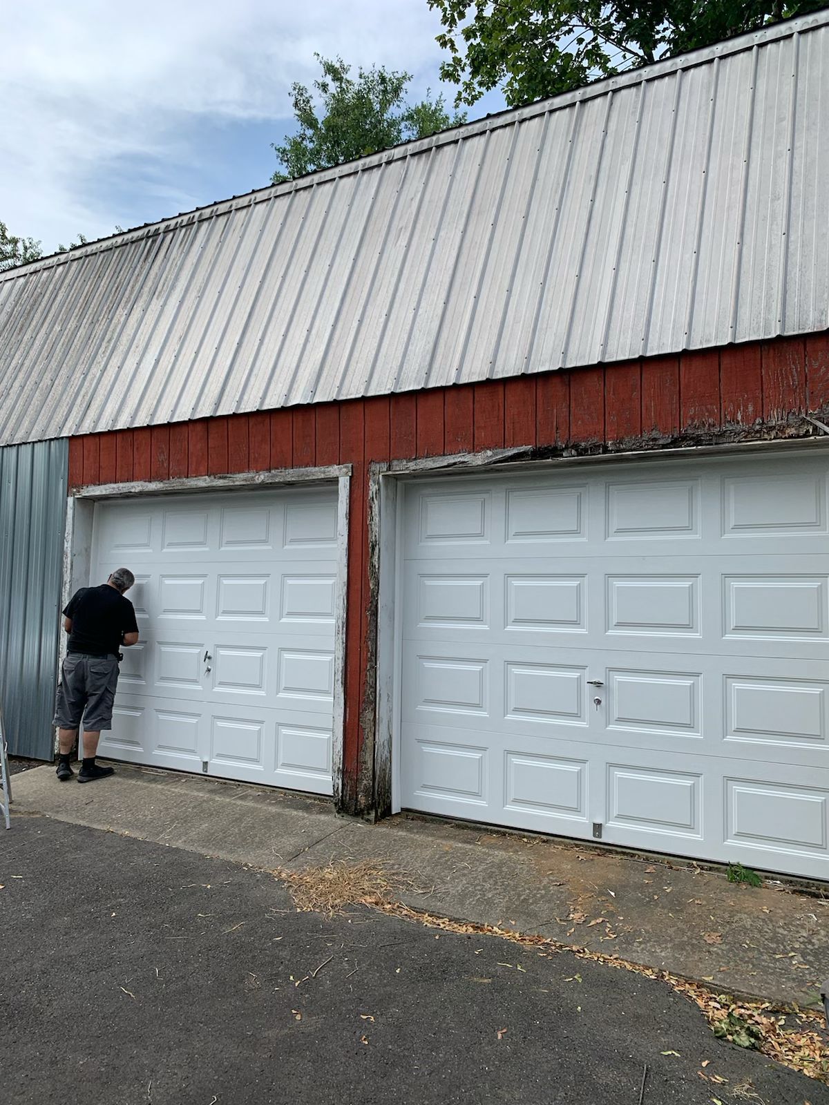 A man is standing in front of a garage door – New Jersey - Local Garage Door
