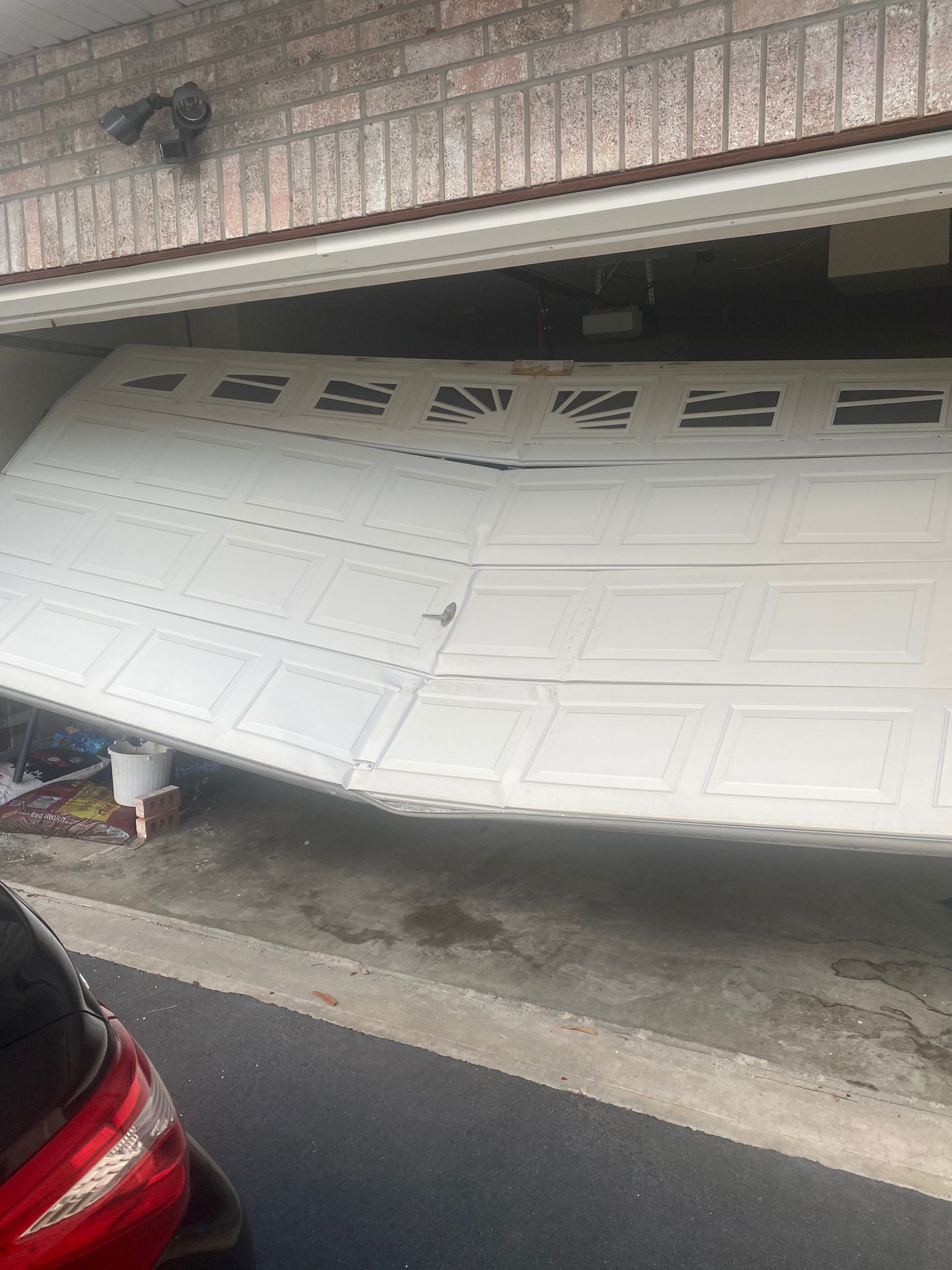A car is parked in front of a garage door that has fallen off – New Jersey - Local Garage Door