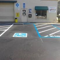 Exterior view of a building with a designated handicap parking space.