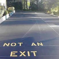 Asphalt road with yellow text reading 