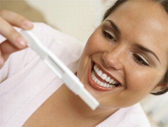 woman reading a pregnancy test