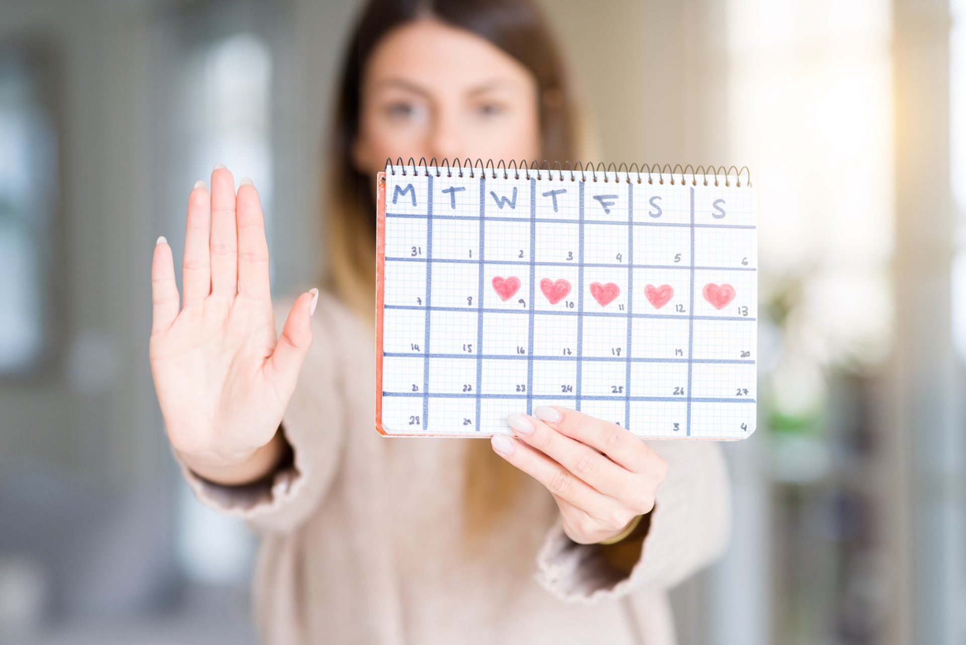 Woman Holding Menstruation Calendar — Orlando, FL — Jack G. Faup, M.D.