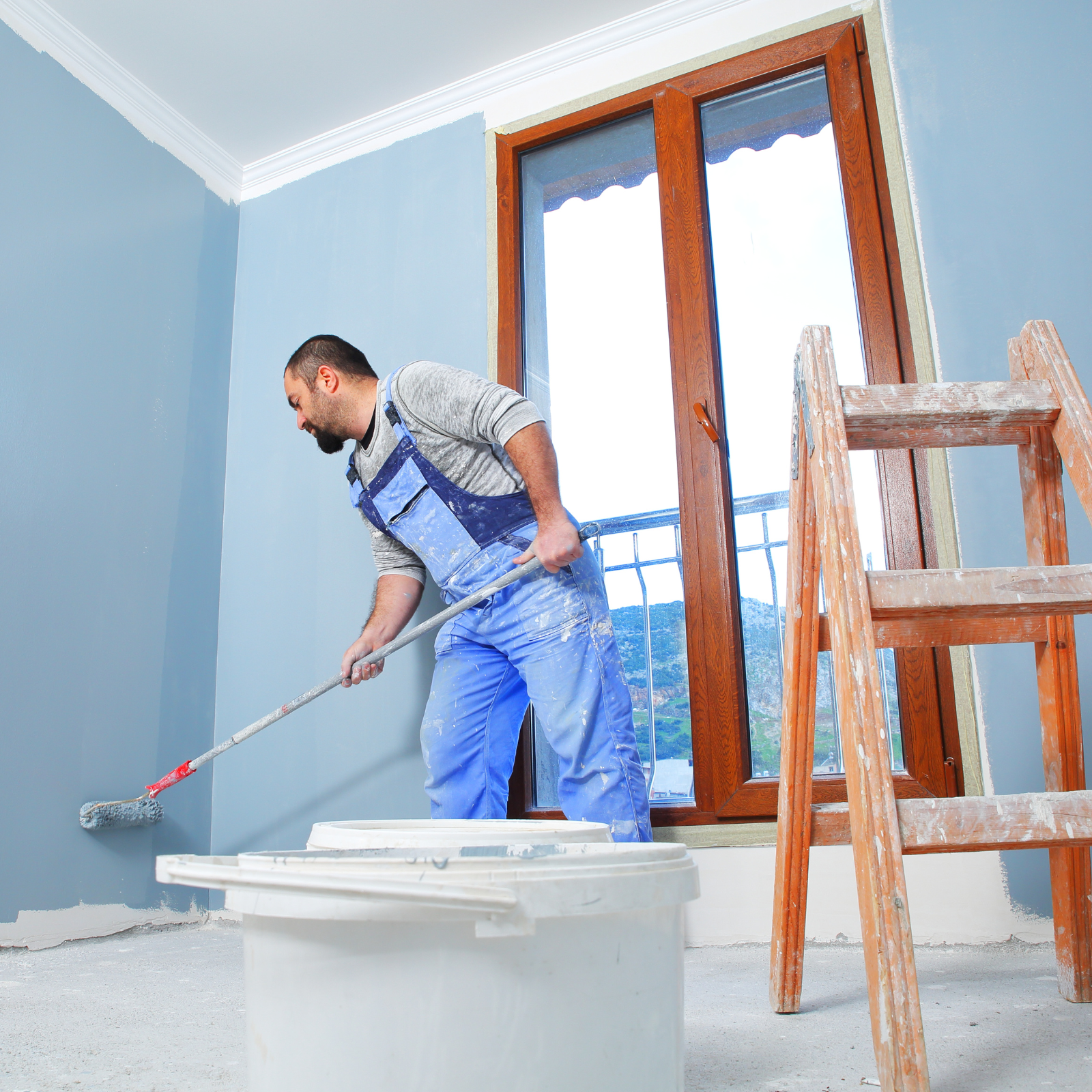 Professional painter painting a wall