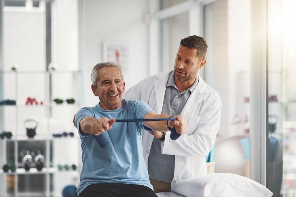 Man with neck pain, red highlight on spine, sitting on bed.