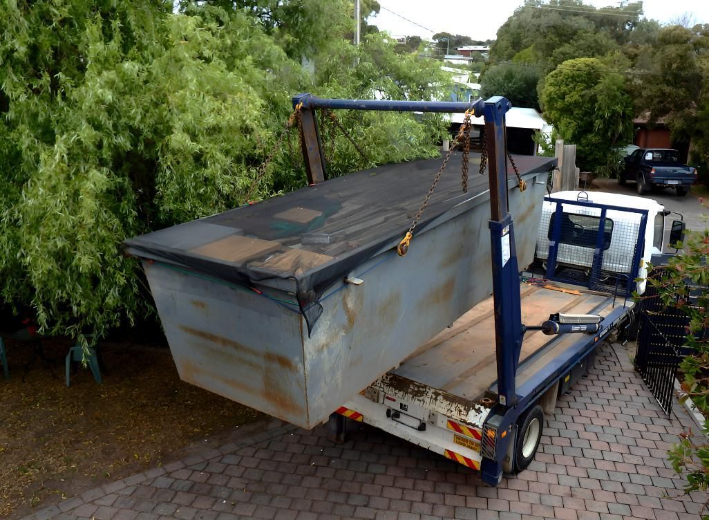Dumpster is Sitting on the Back of a Truck — Maryborough Recycling in Maryborough, QLD