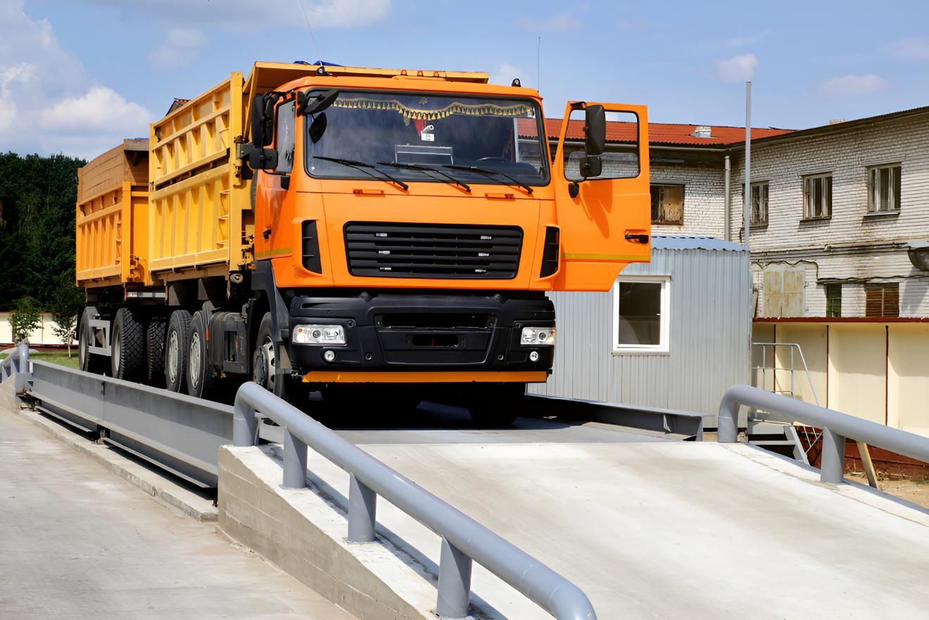 Orange Dump Truck Weighing on Weighbridge — Maryborough Recycling in Mount Perry, QLD