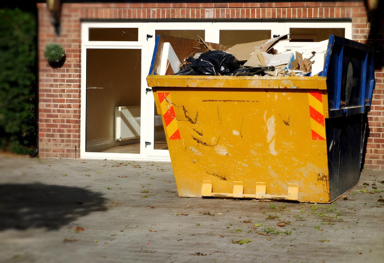 Yellow Dumpster is Sitting in Front of Building — Maryborough Recycling in Howard, QLD