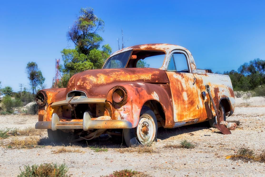 Old Rusty Truck is Sitting in the Middle of a Dirt Field — Maryborough Recycling in Tiaro, QLD