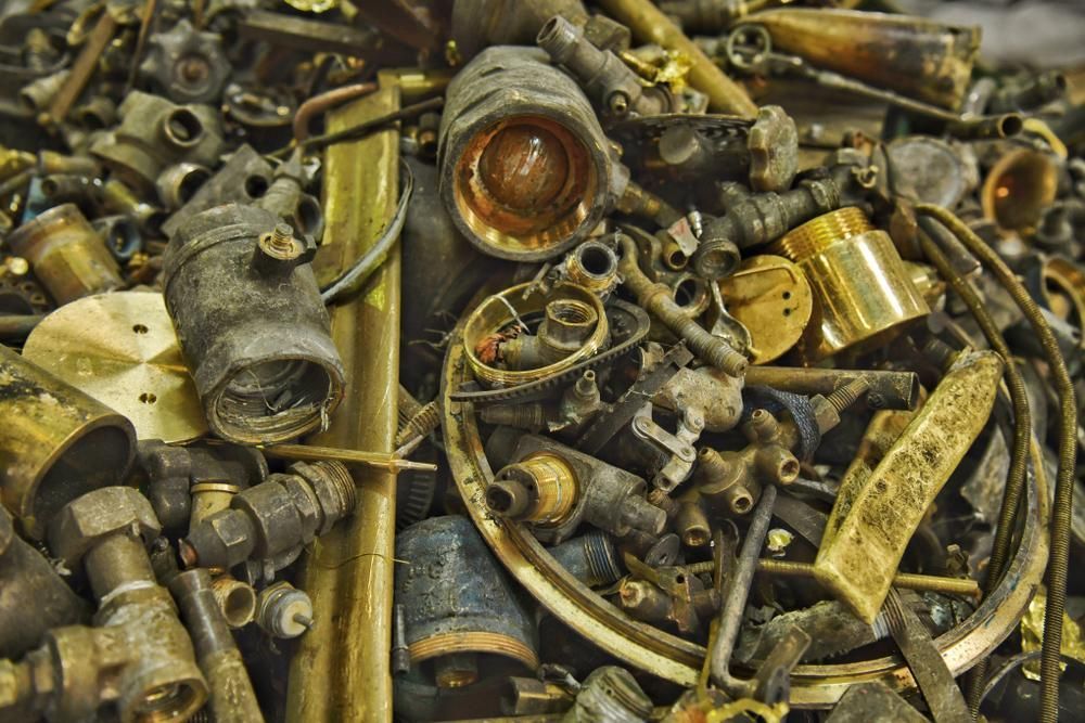 Pile of Brass Scrap is Sitting on a Table — Maryborough Recycling in Boonooroo, QLD
