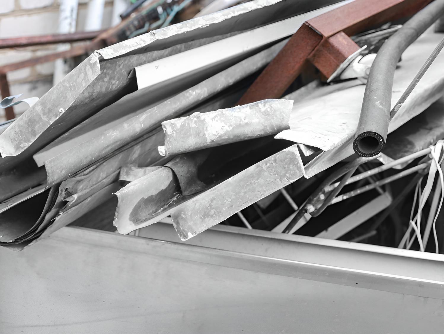 Pile of Scrap Metal is Sitting in a Bin — Maryborough Recycling in Rainbow Beach, QLD