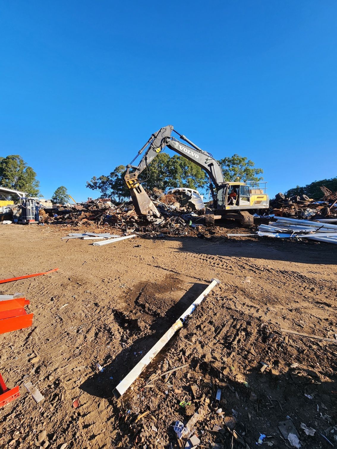 Excavator is Working on a Pile of Metal — Maryborough Recycling in Gin Gin, QLD