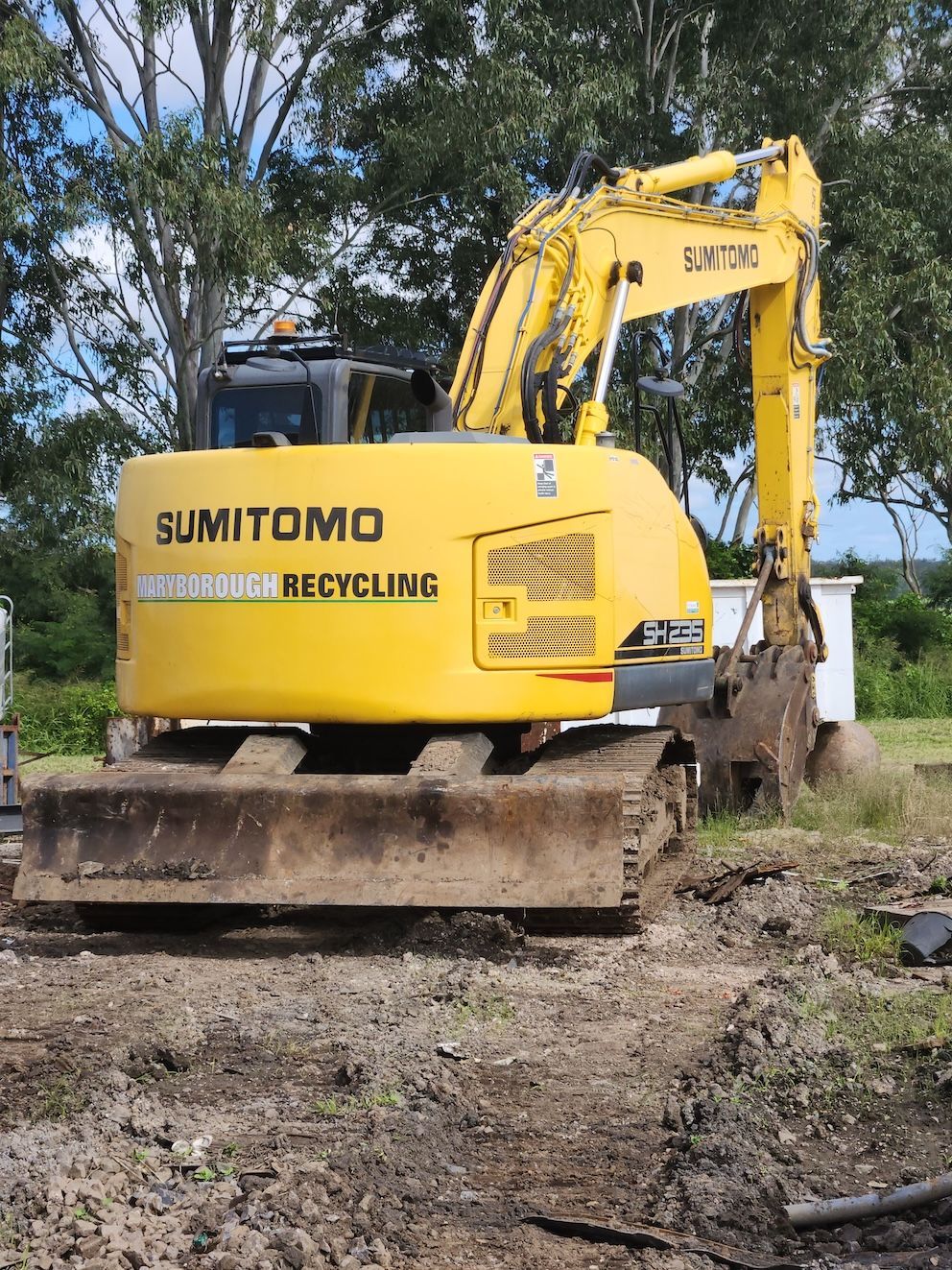 Backhoe In Field — Maryborough Recycling in Maryborough, QLD