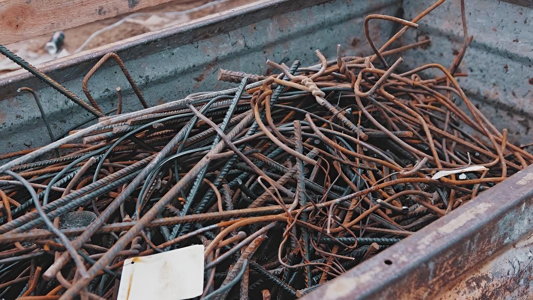 Pile of Rusty Metal Bars in a Metal Container — Maryborough Recycling in Bauple, QLD