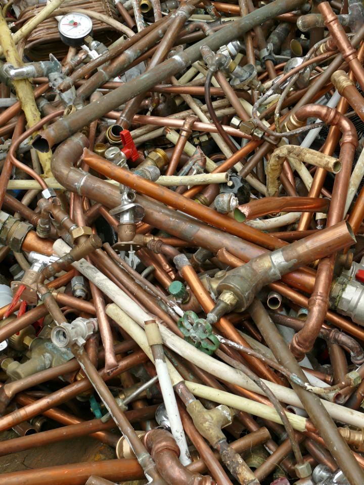 Pile of Copper Pipes and Fittings is Sitting on the Ground — Maryborough Recycling in Maryborough, QLD