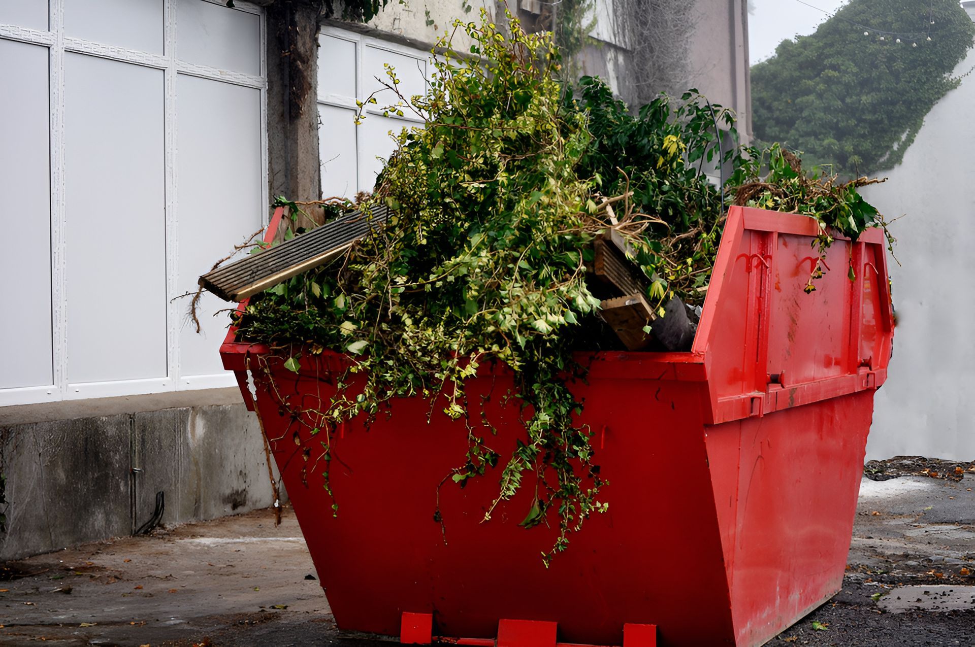 Red Dumpster Filled With Leaves — Maryborough Recycling in Bauple, QLD