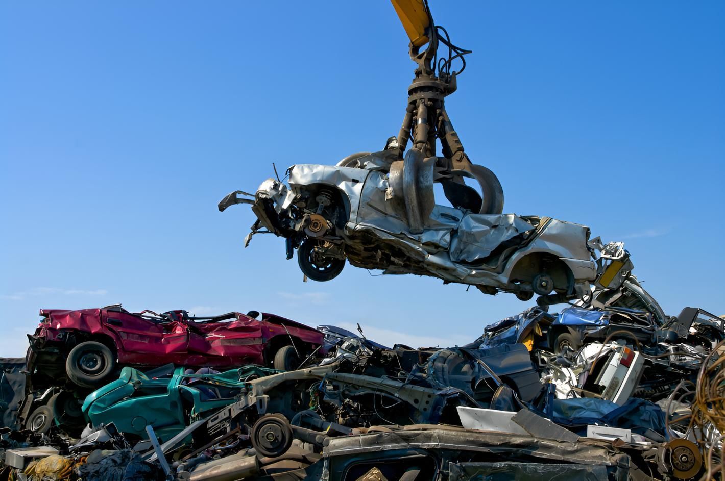 Crane is Lifting a Car Out of a Pile of Scrap Metal — Maryborough Recycling in Ban Ban Springs, QLD