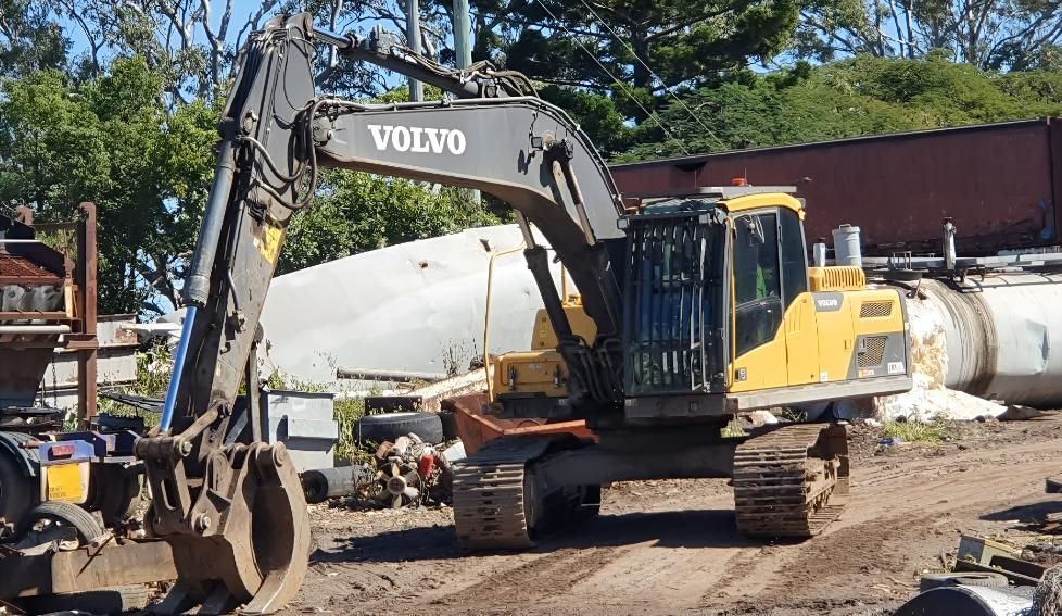Yellow and Black Volvo Excavator is Parked in a Dirt Lot — Maryborough Recycling in Maryborough, QLD