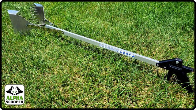 A scooper is sitting on top of a lush green field.