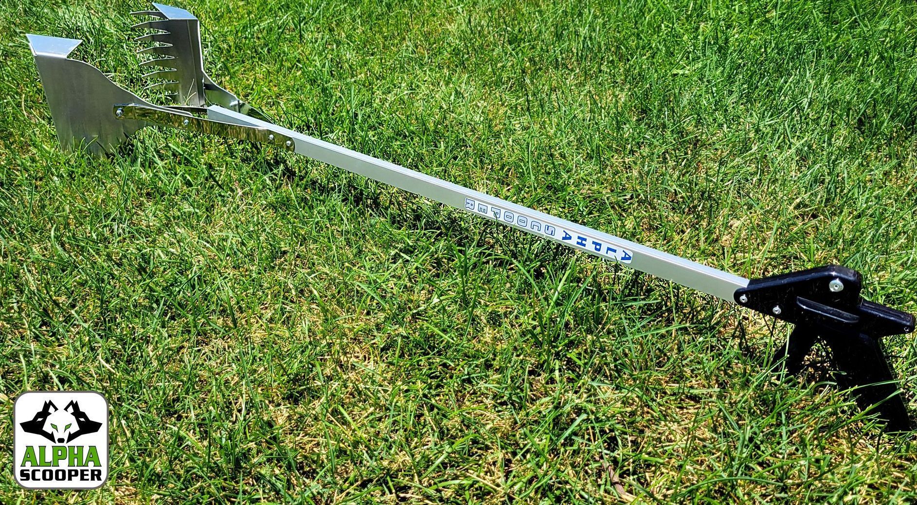 A scooper is sitting on top of a lush green field.