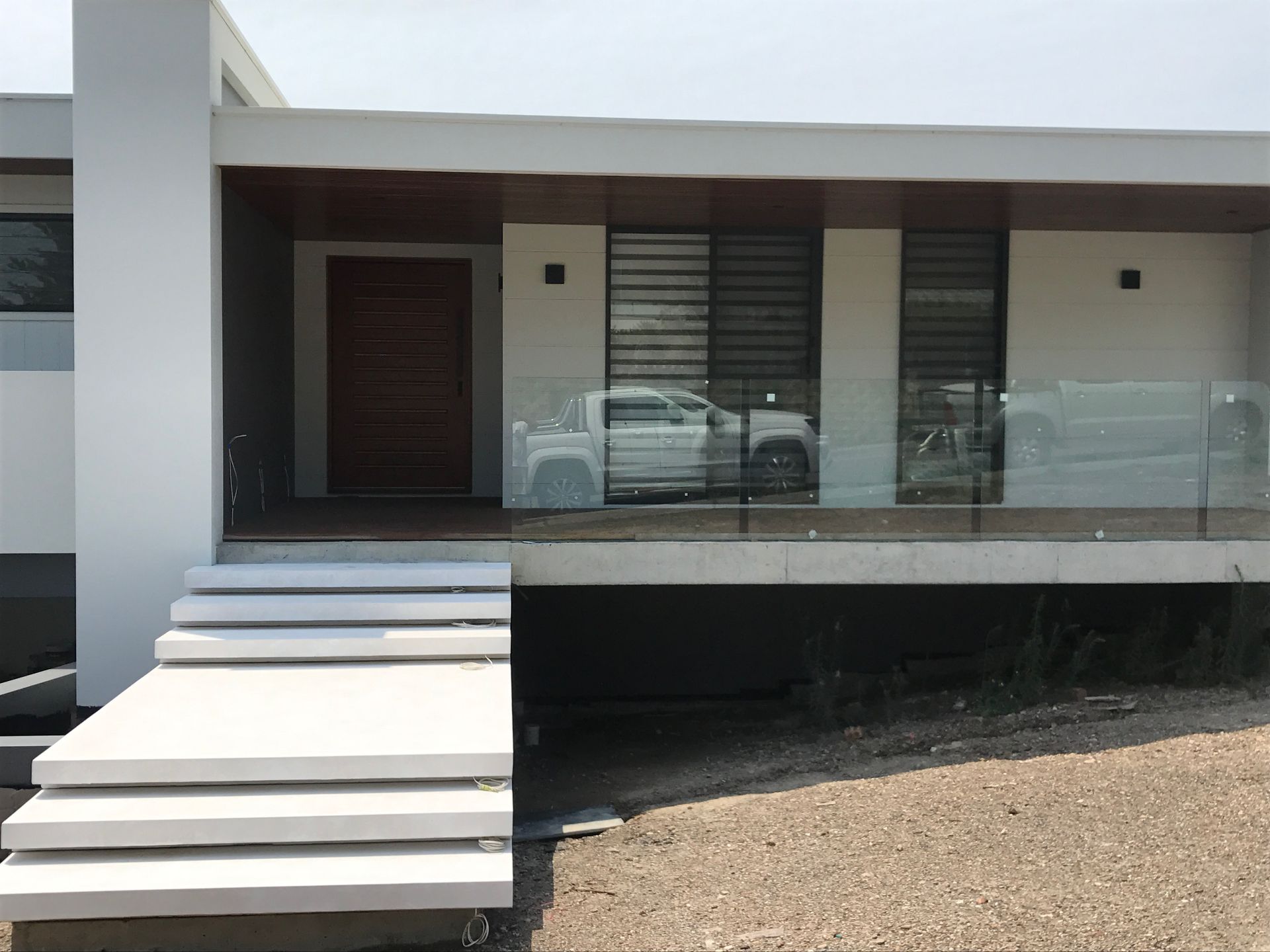 workers using rollers to paint an external wall