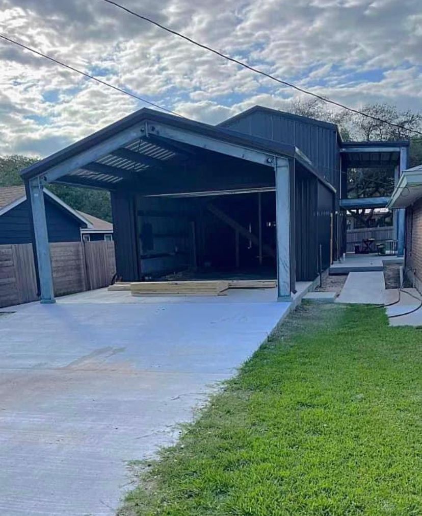 A garage is being built in the backyard of a house.