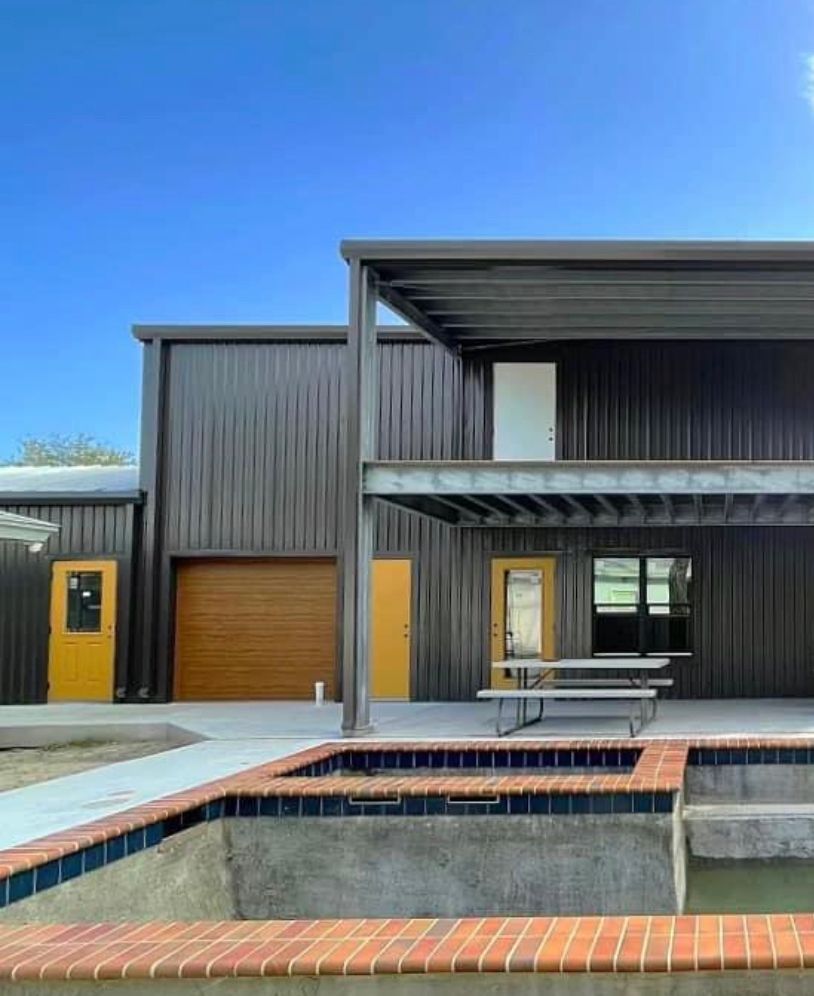 A large house with a swimming pool in front of it