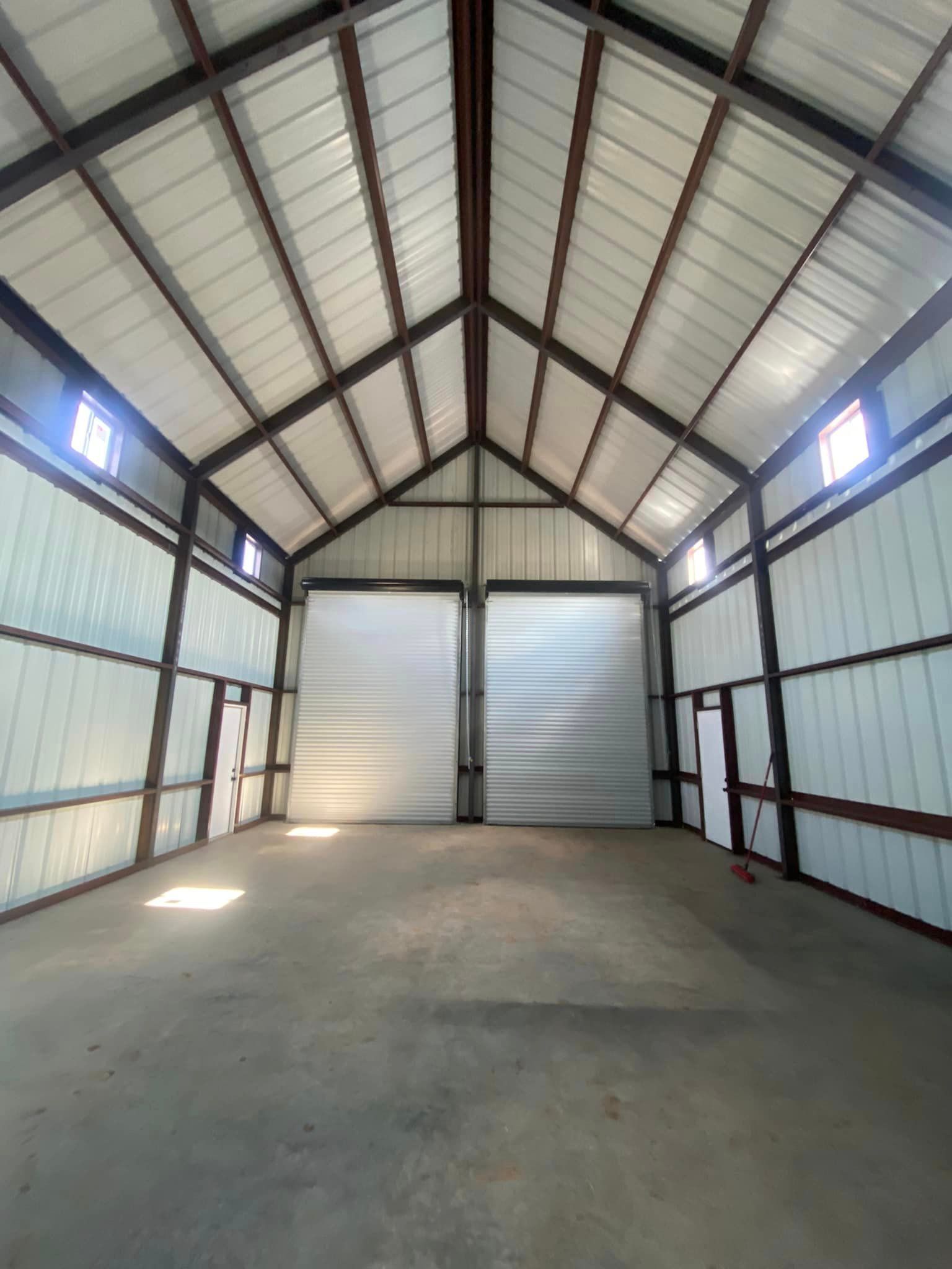 A large empty warehouse with a vaulted ceiling