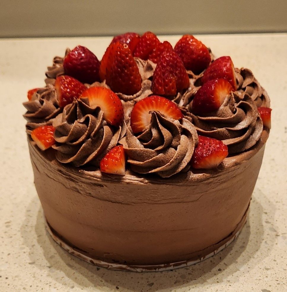 Chocolate cake with chocolate frosting and strawberries.