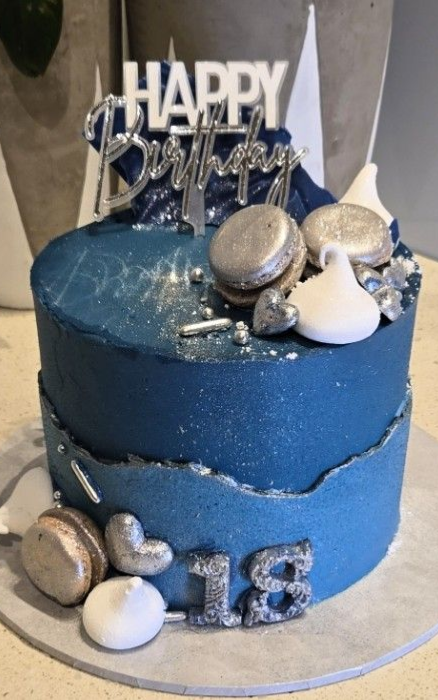 Blue birthday cake with silver decorations and 