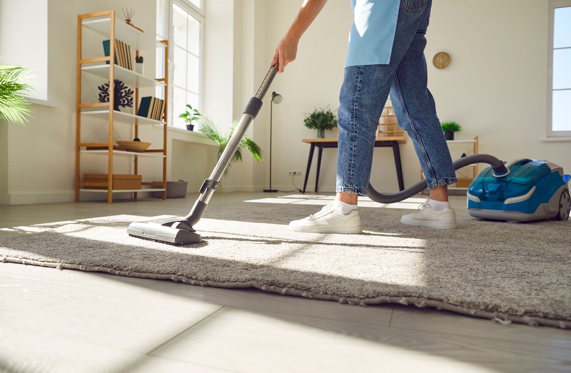 Vacuuming a Carpet in A Living Room