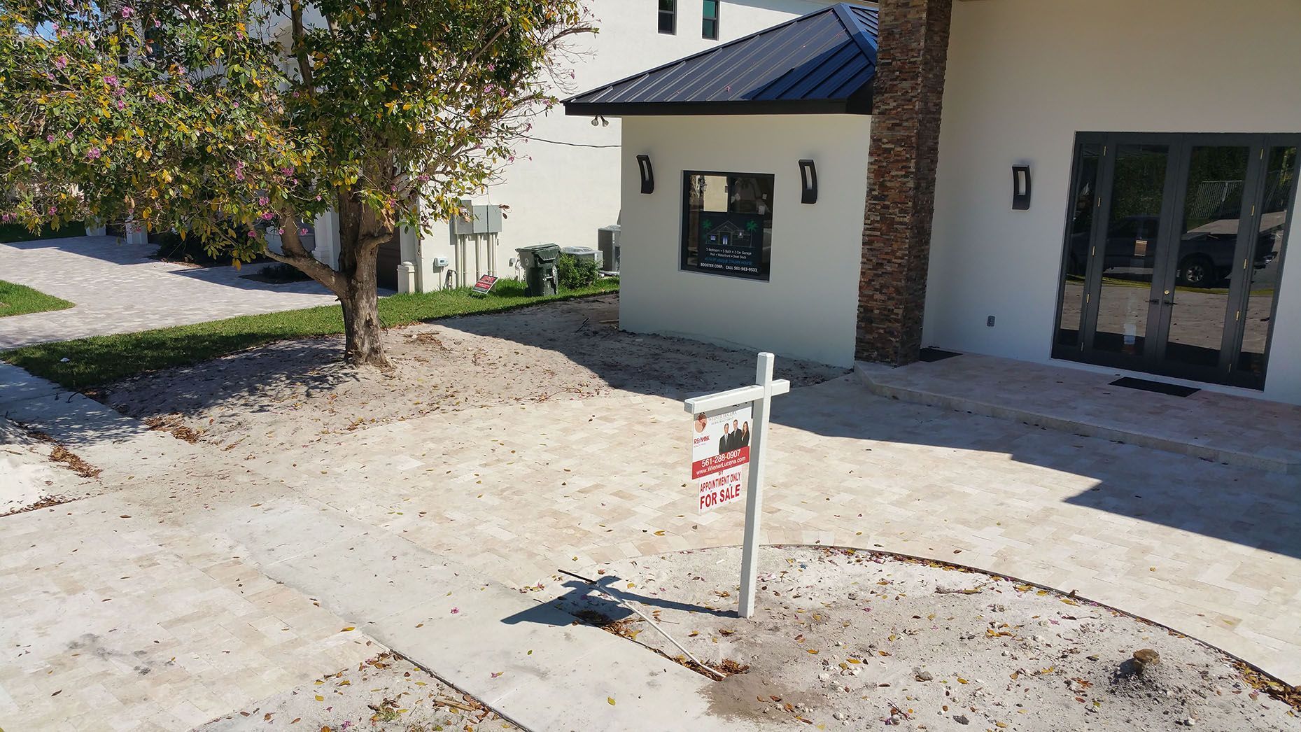 A white house with a for sale sign in front of it