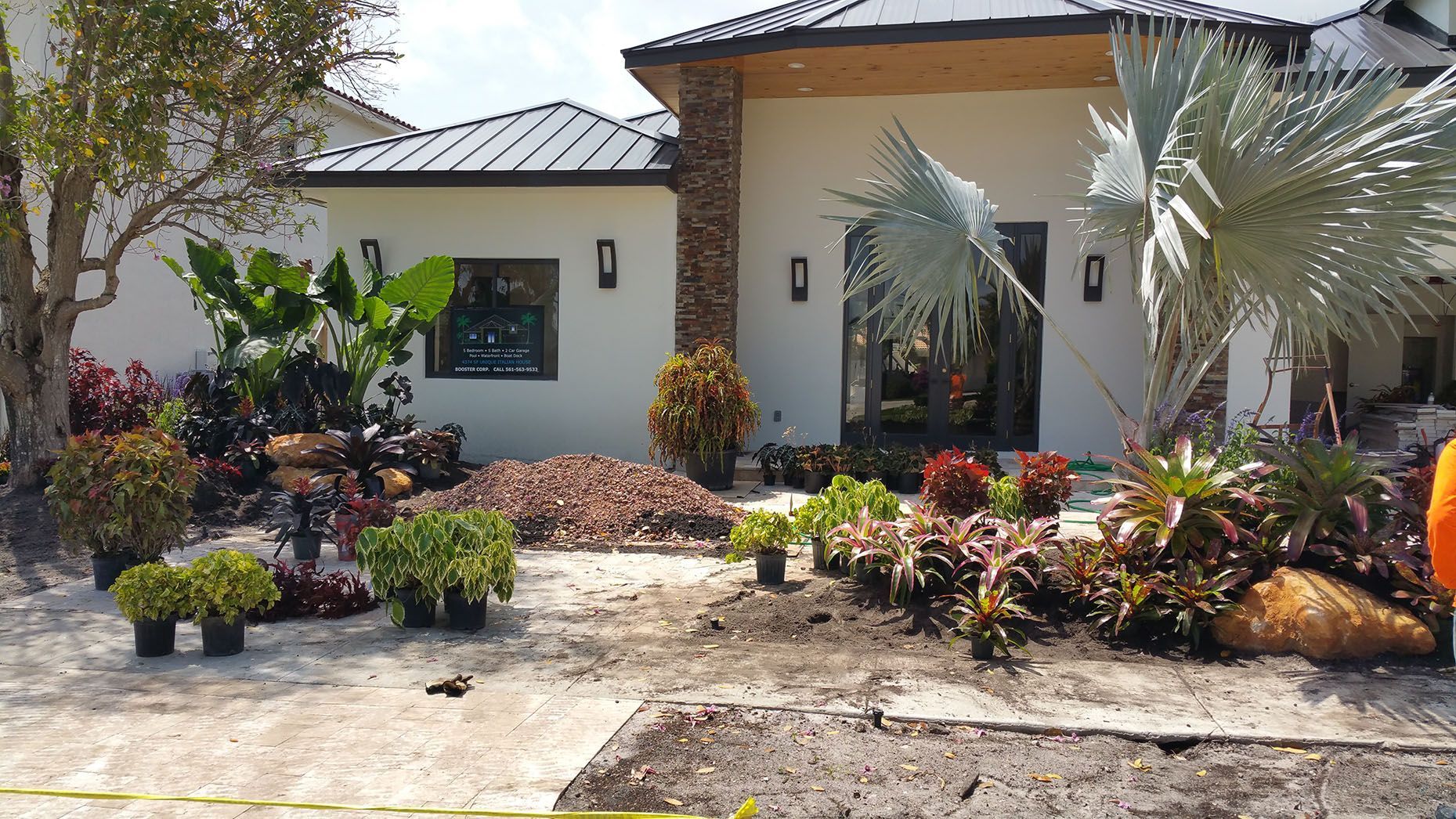 A house with a lot of plants in front of it