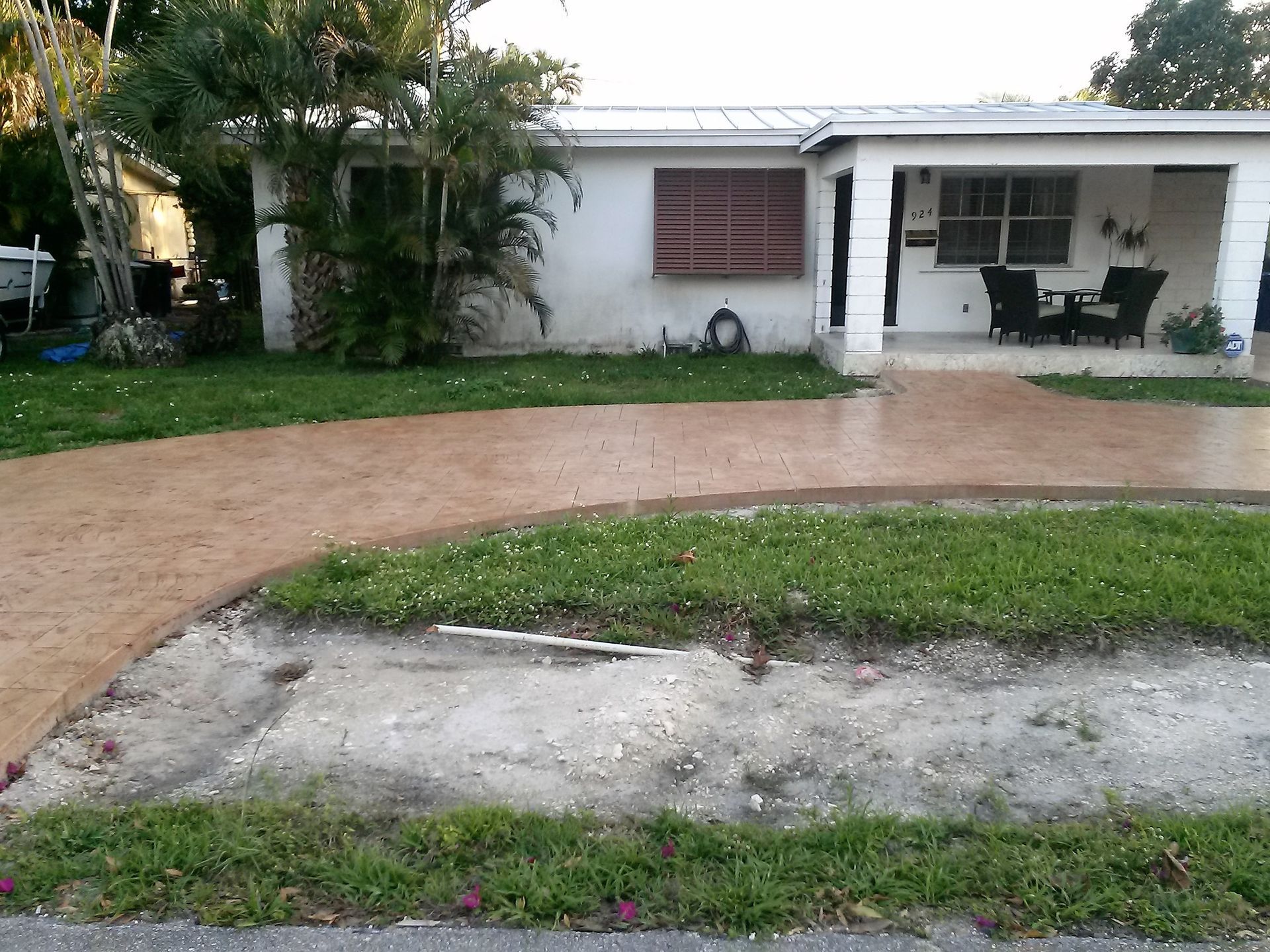 A house with a concrete driveway in front of it