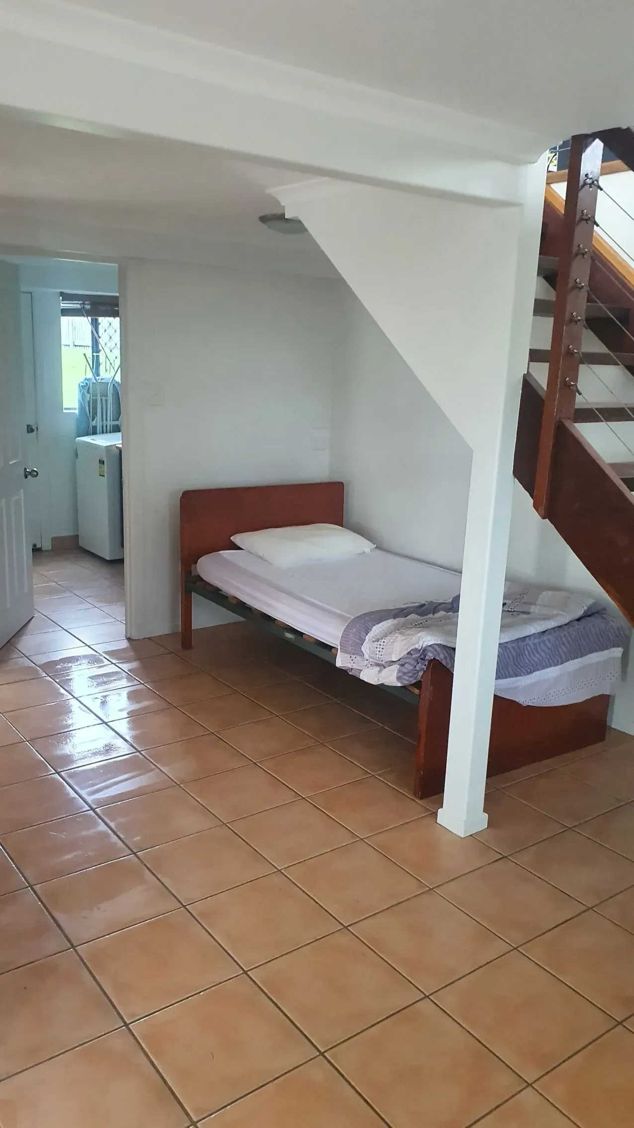 Bedroom With Bed, Under Stairs, Tiled Floor — Keppel Coatings in Pacific Heights, QLD