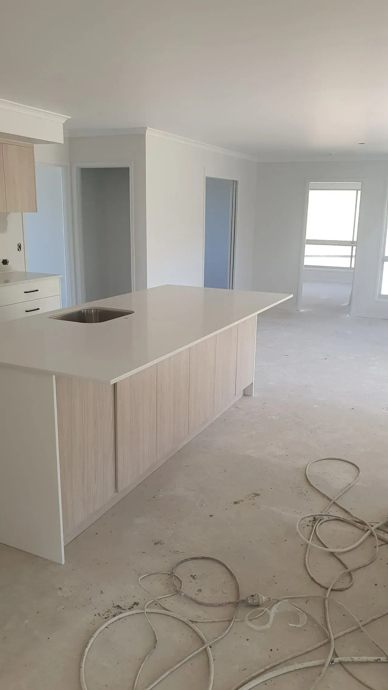 Kitchen Island With Light Wood Cabinets — Keppel Coatings in Pacific Heights, QLD