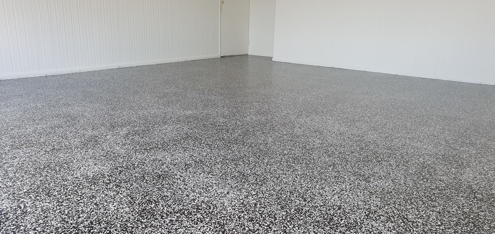 Room Corner With a Speckled, Gray Floor and White Walls — Keppel Coatings in Pacific Heights, QLD