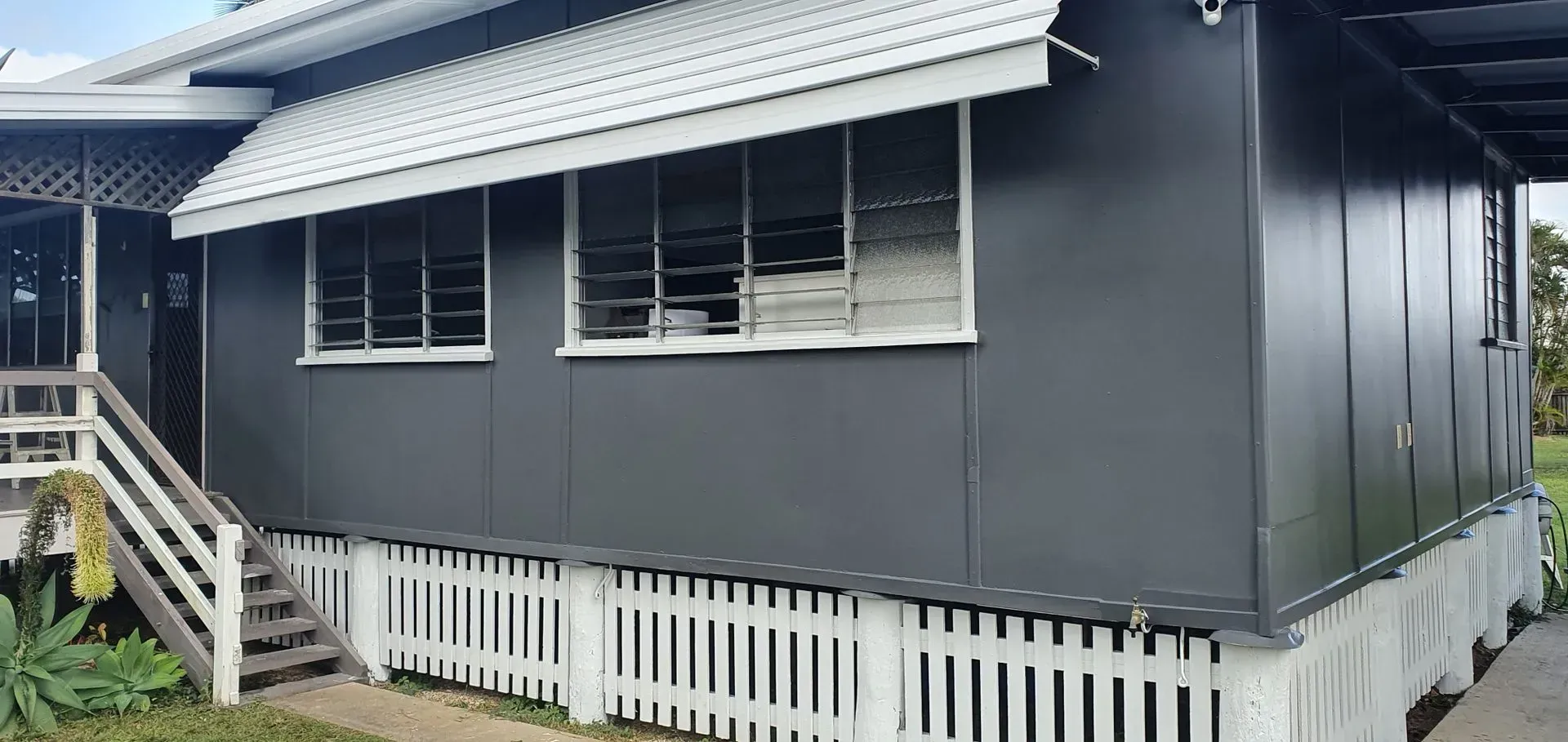 Gray House With White Picket Fence, Steps, and Awning — Keppel Coatings in Pacific Heights, QLD