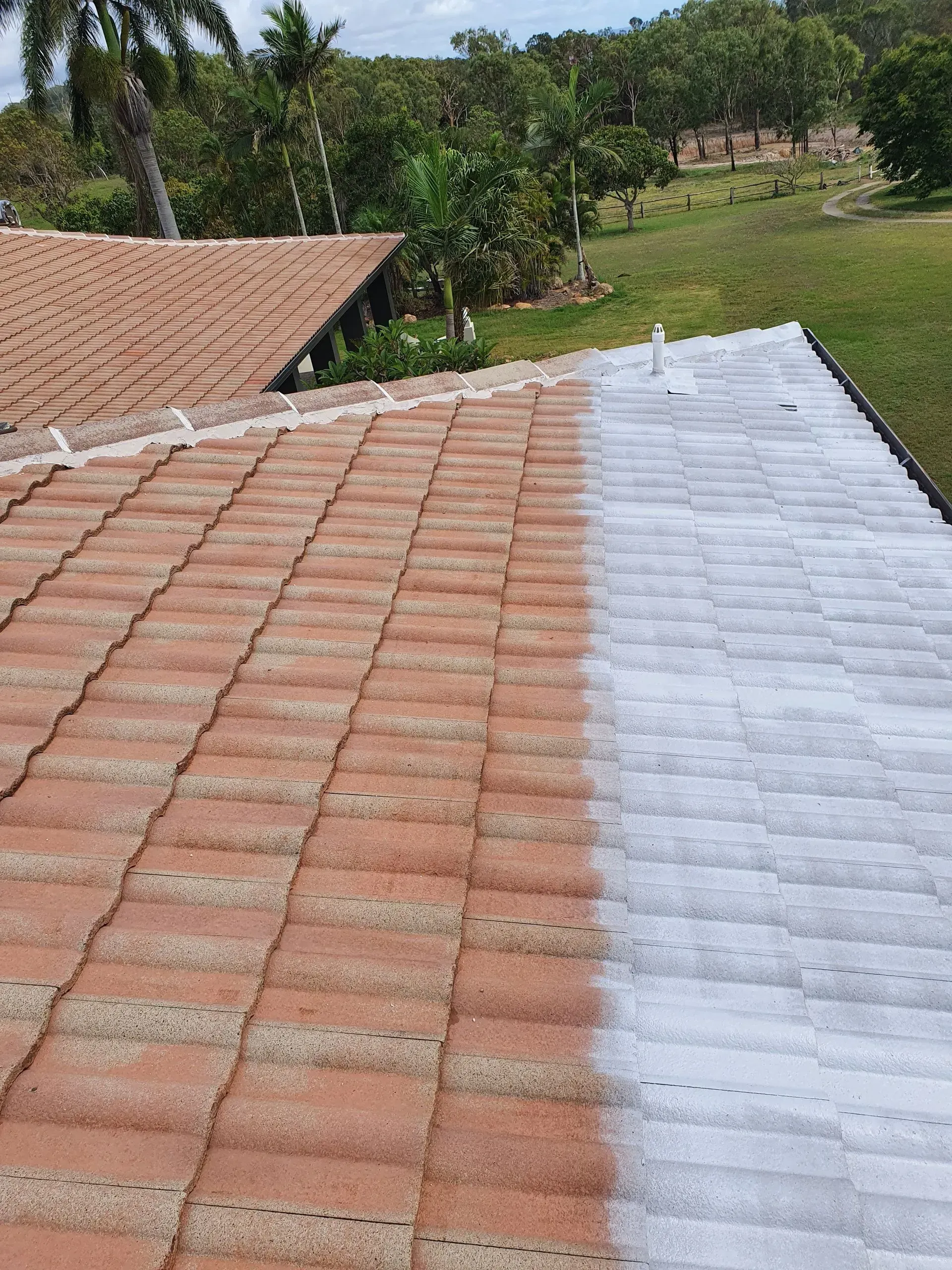 Red Tile Roof With a White Painted Section — Keppel Coatings in Pacific Heights, QLD