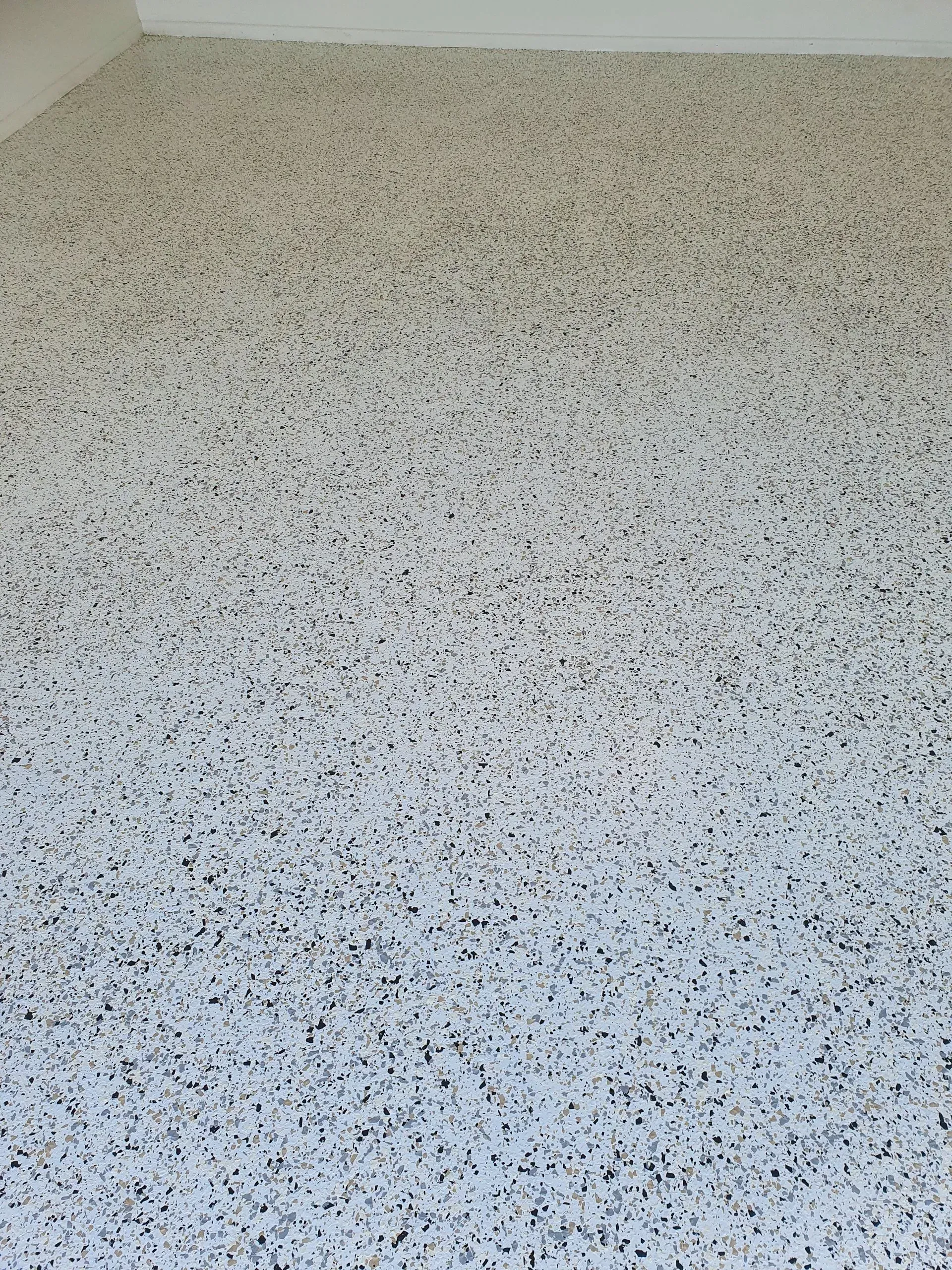 Speckled Epoxy Flooring in Shades of White, Gray, and Black — Keppel Coatings in Pacific Heights, QLD