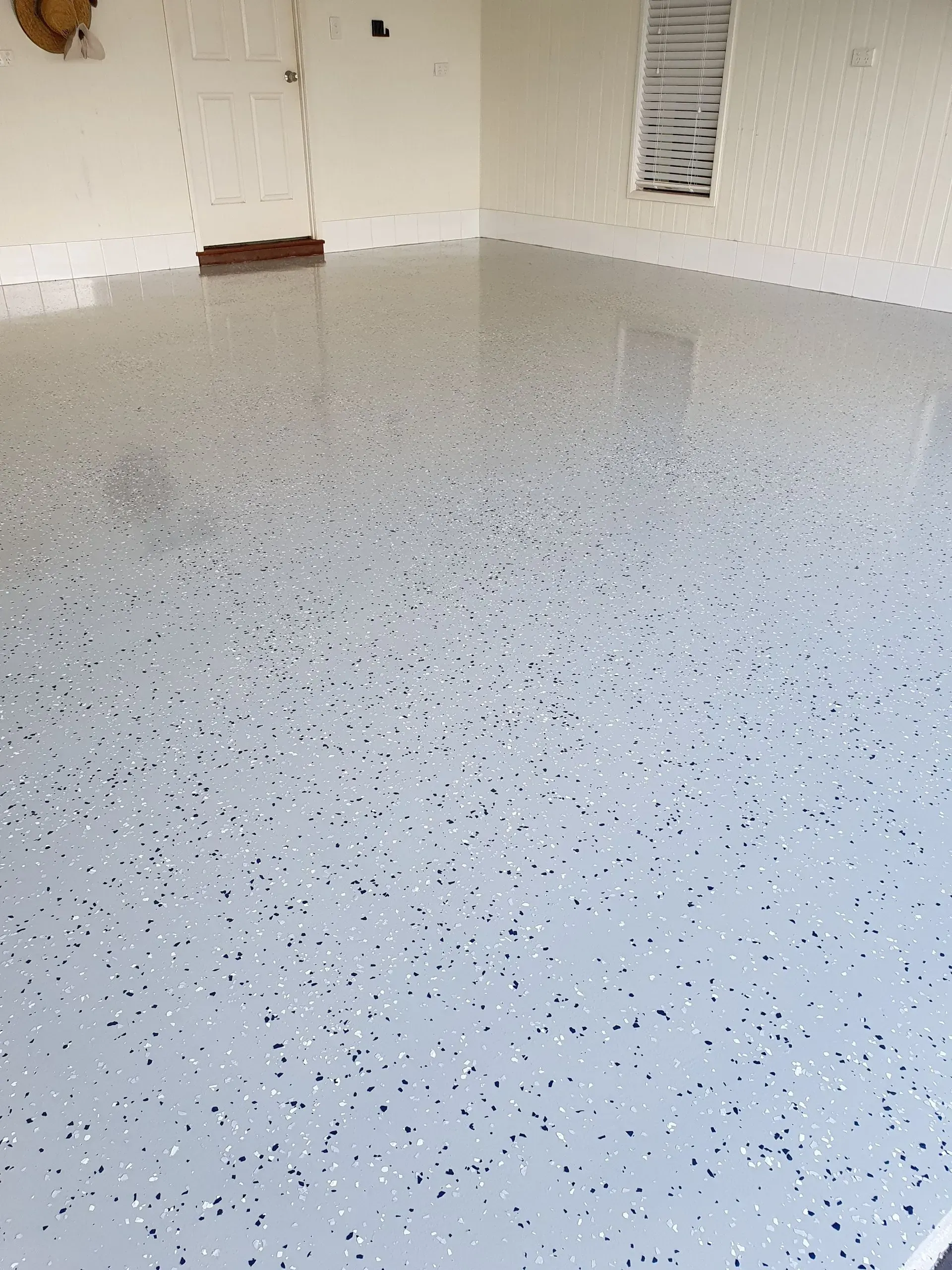 Gray Epoxy-coated Garage Floor With Scattered Flakes — Keppel Coatings in Pacific Heights, QLD