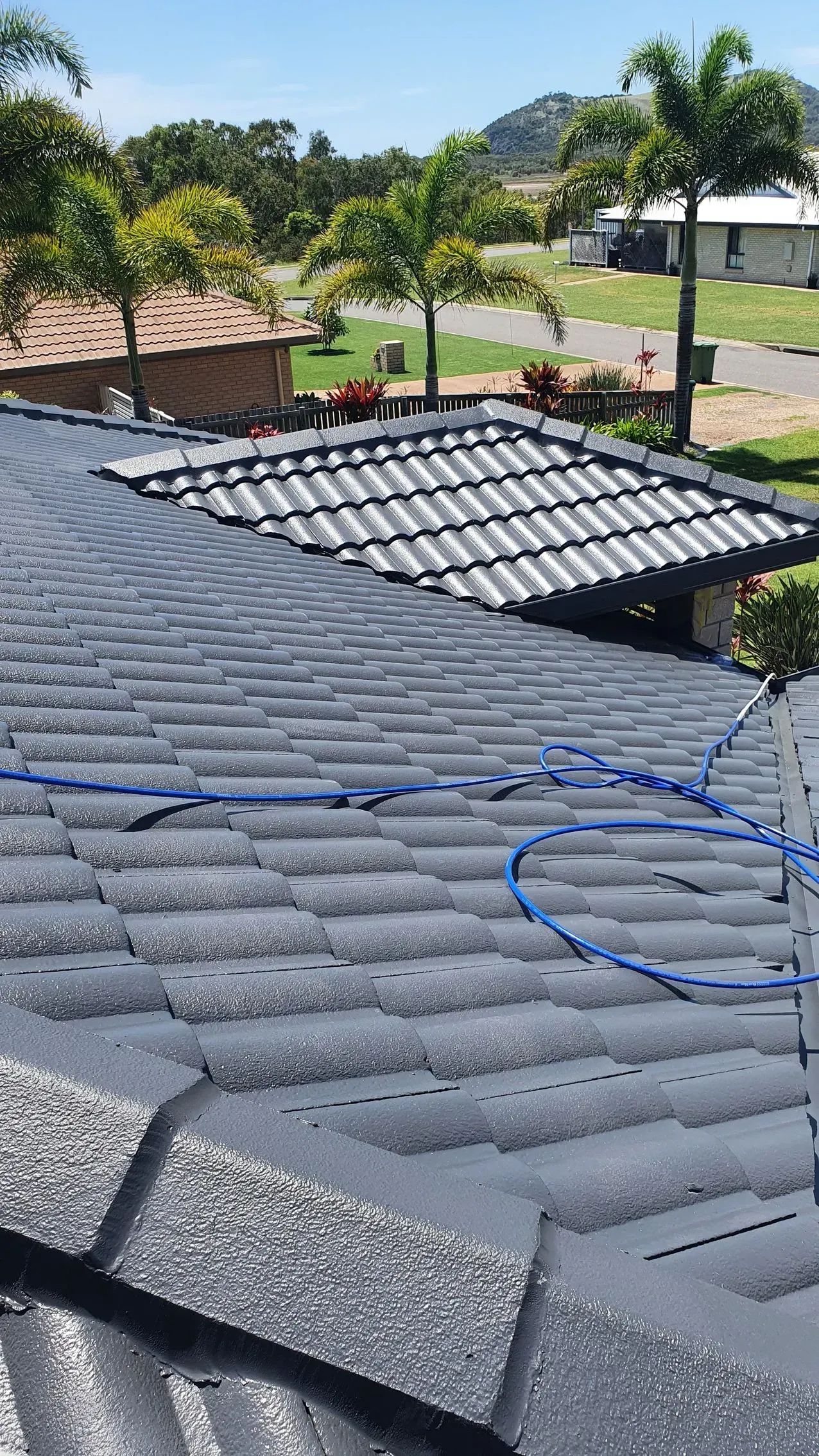 Gray Shingled Roof With a Smaller, Tile-roofed Section — Keppel Coatings in Pacific Heights, QLD