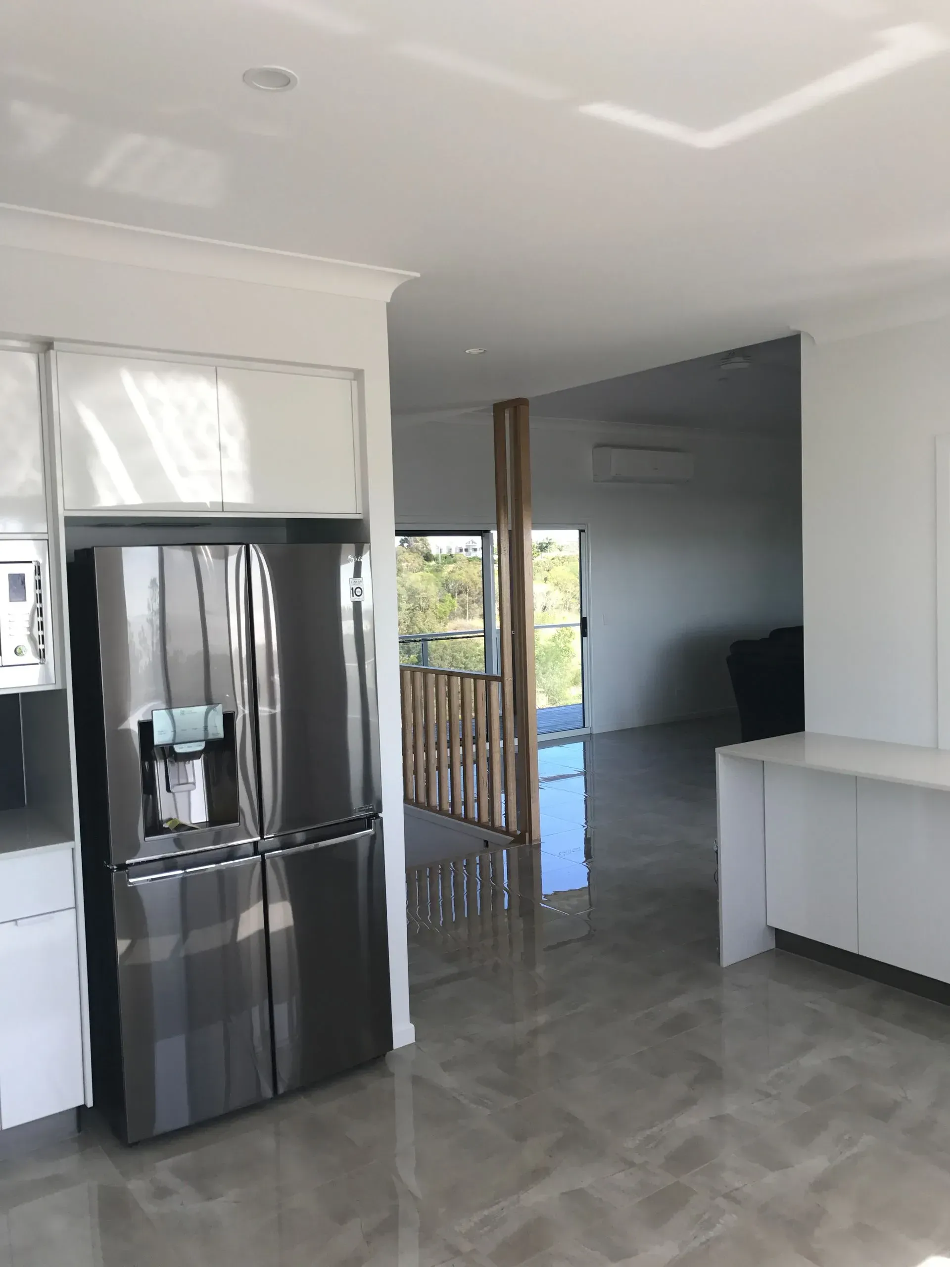 Interior View of a Modern Kitchen With Stainless Steel Refrigerator — Keppel Coatings in Pacific Heights, QLD