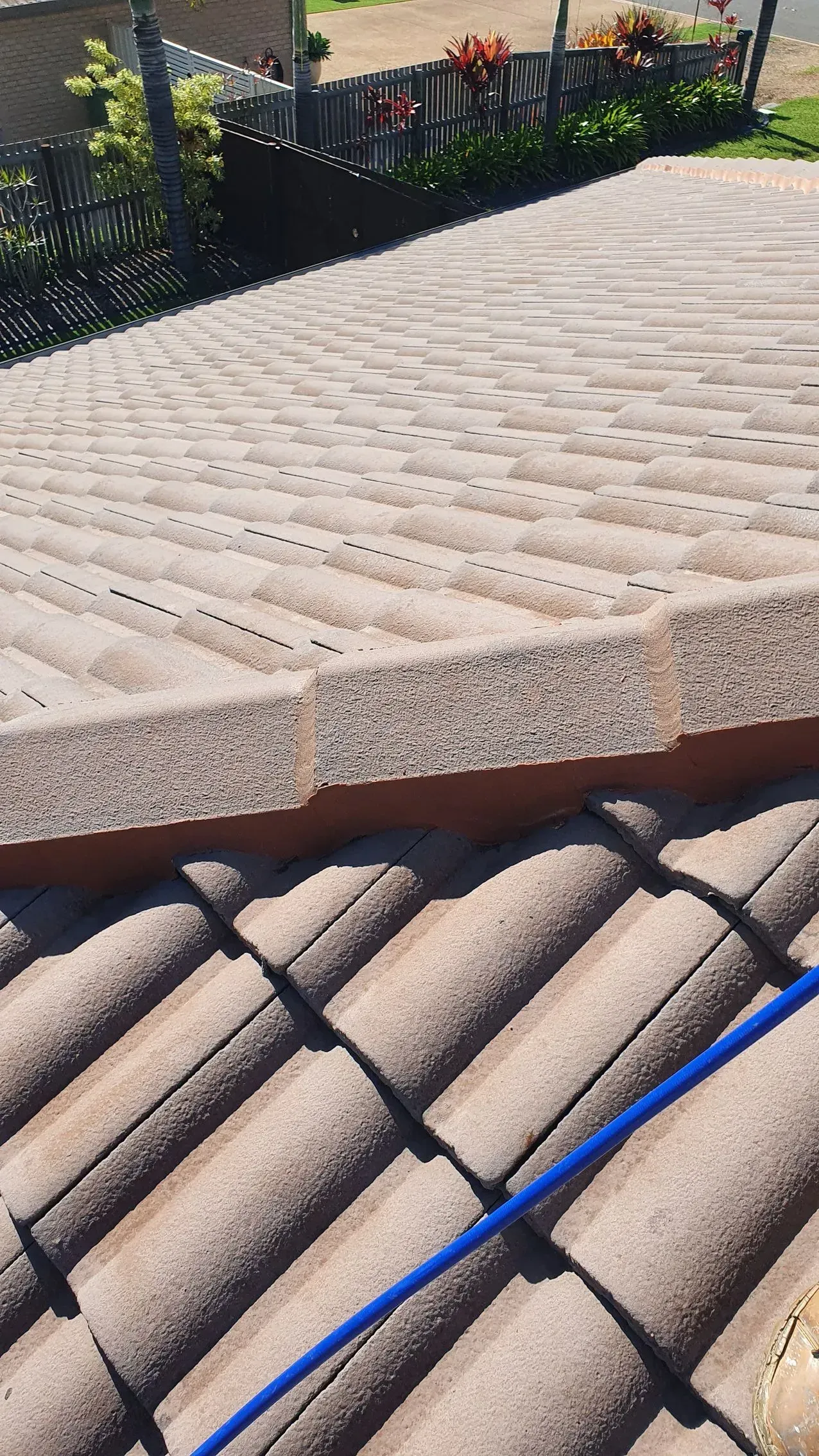 Close-up of Brown Roof Tiles; Top Row Has a Flat Surface — Keppel Coatings in Pacific Heights, QLD