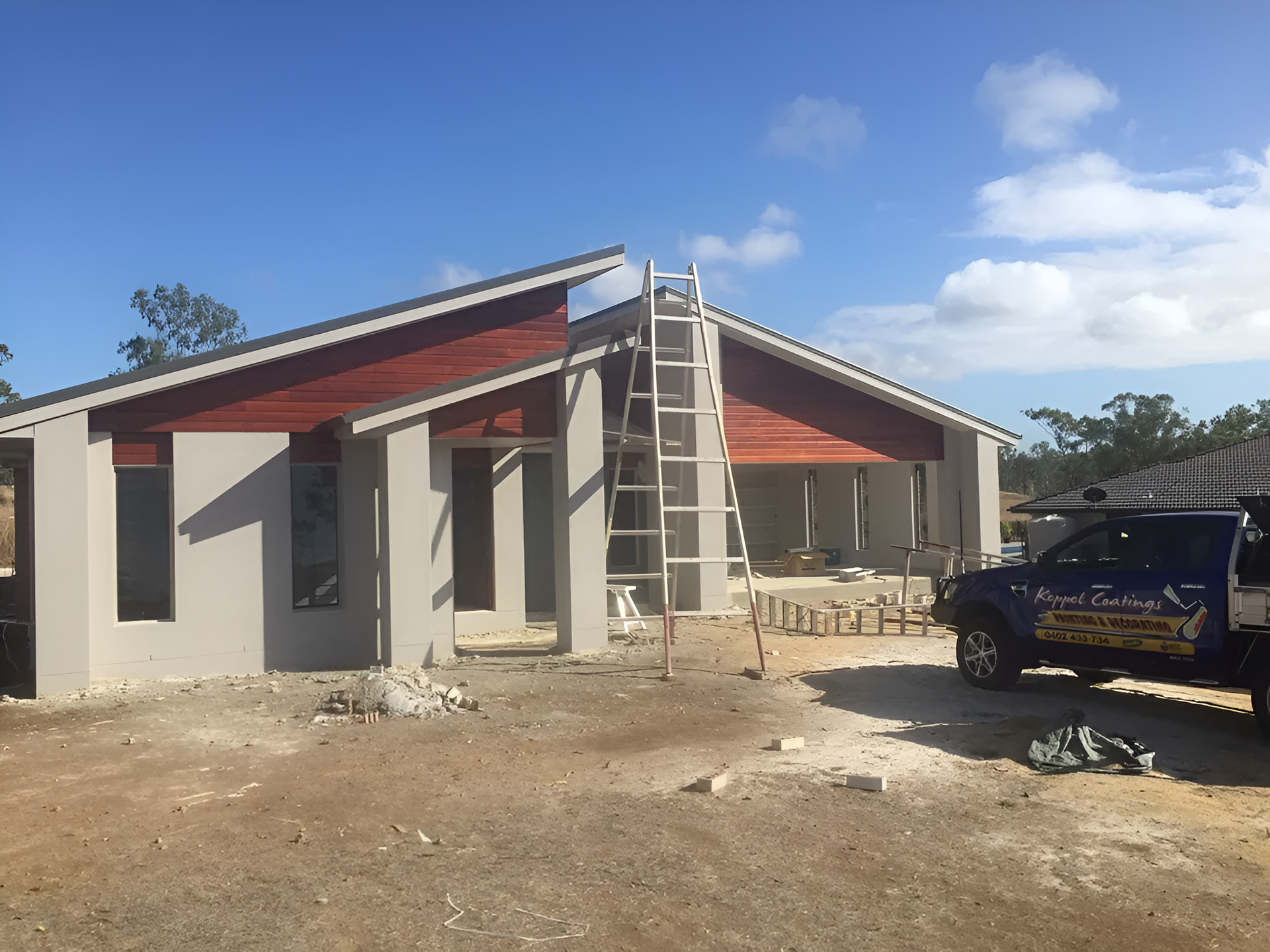 Construction of a Modern House, Gray Walls, Red Roof Trim — Keppel Coatings in Pacific Heights, QLD
